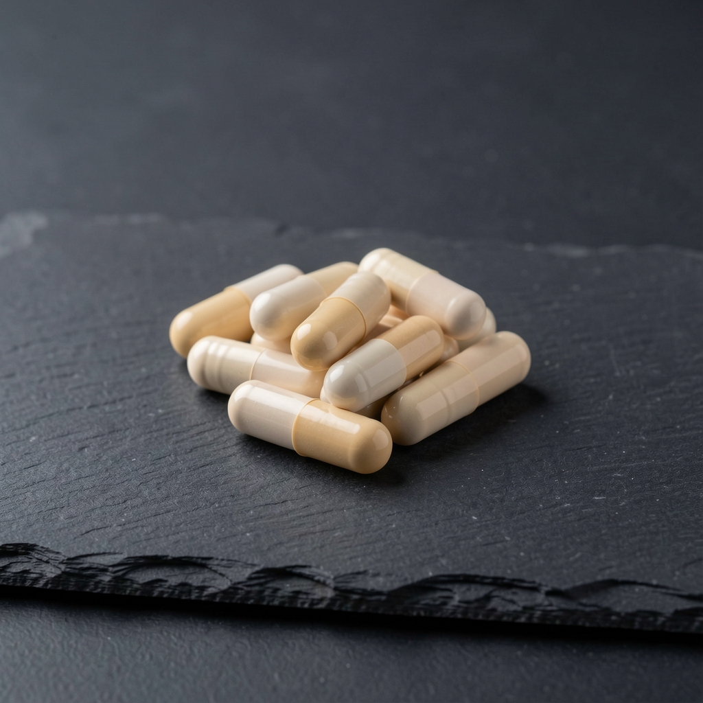 Energy and endurance nutritional supplement with capsule shell detail photographed under controlled studio lighting on slate background